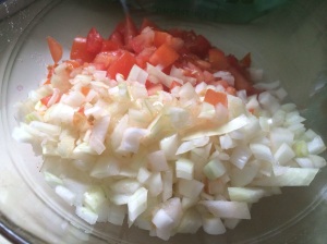 Chopped onions and tomatoes join peppers and scallions in the dish.